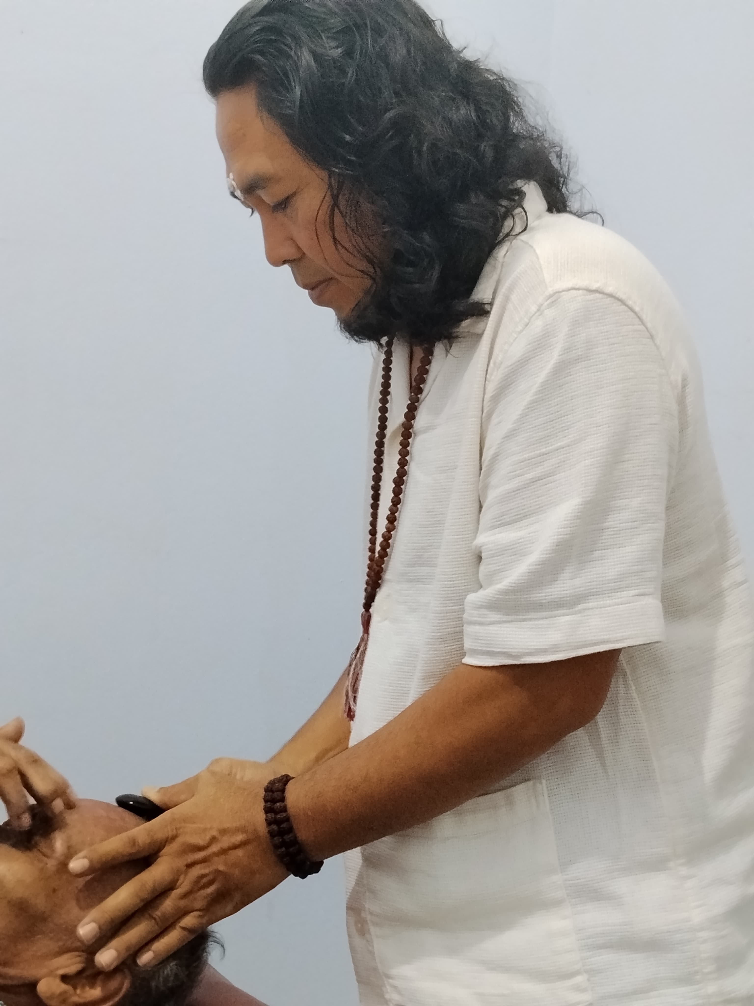 JRO working with his hands on a client during a treatment.