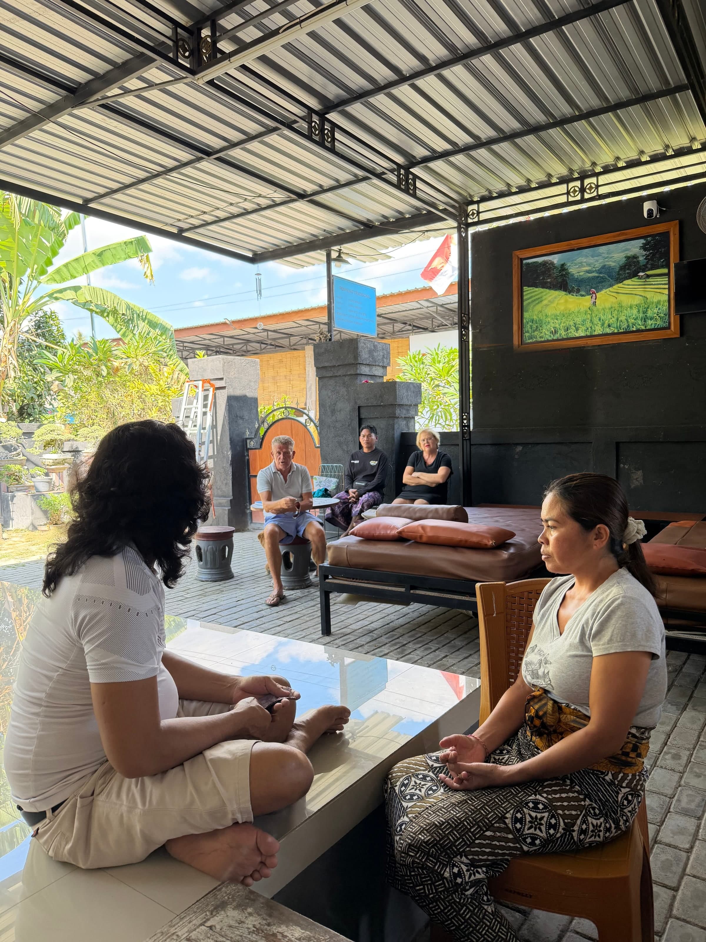 JRO with a client during an open-air healing session in North Bali, others waiting nearby.